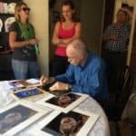 Merlin's signing copies of Nat'l Geo magazine and bat prints for Valerie and Sina, aka Valerina