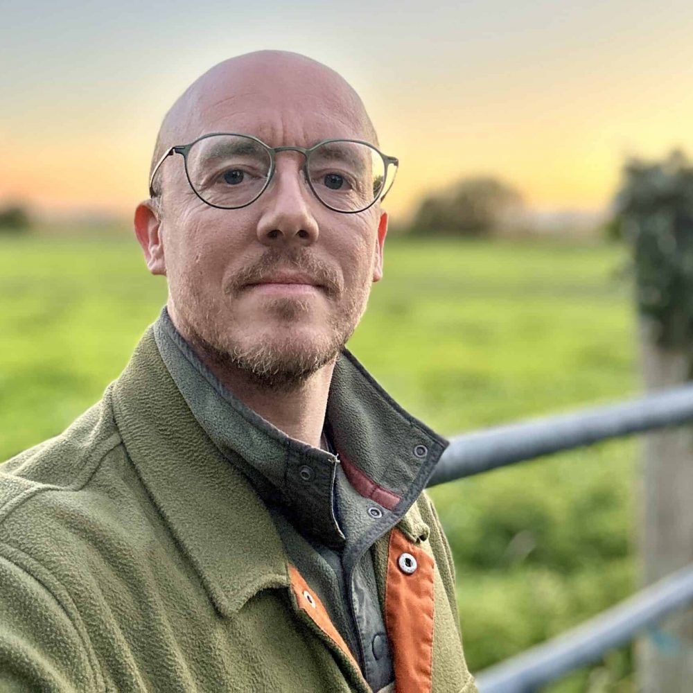 Photo of Daniel Hargreaves, MTBC board member, in a field at sunset