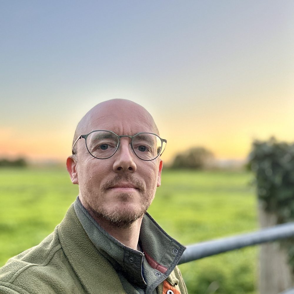 Photo of Daniel Hargreaves, MTBC board member, in a field at sunset